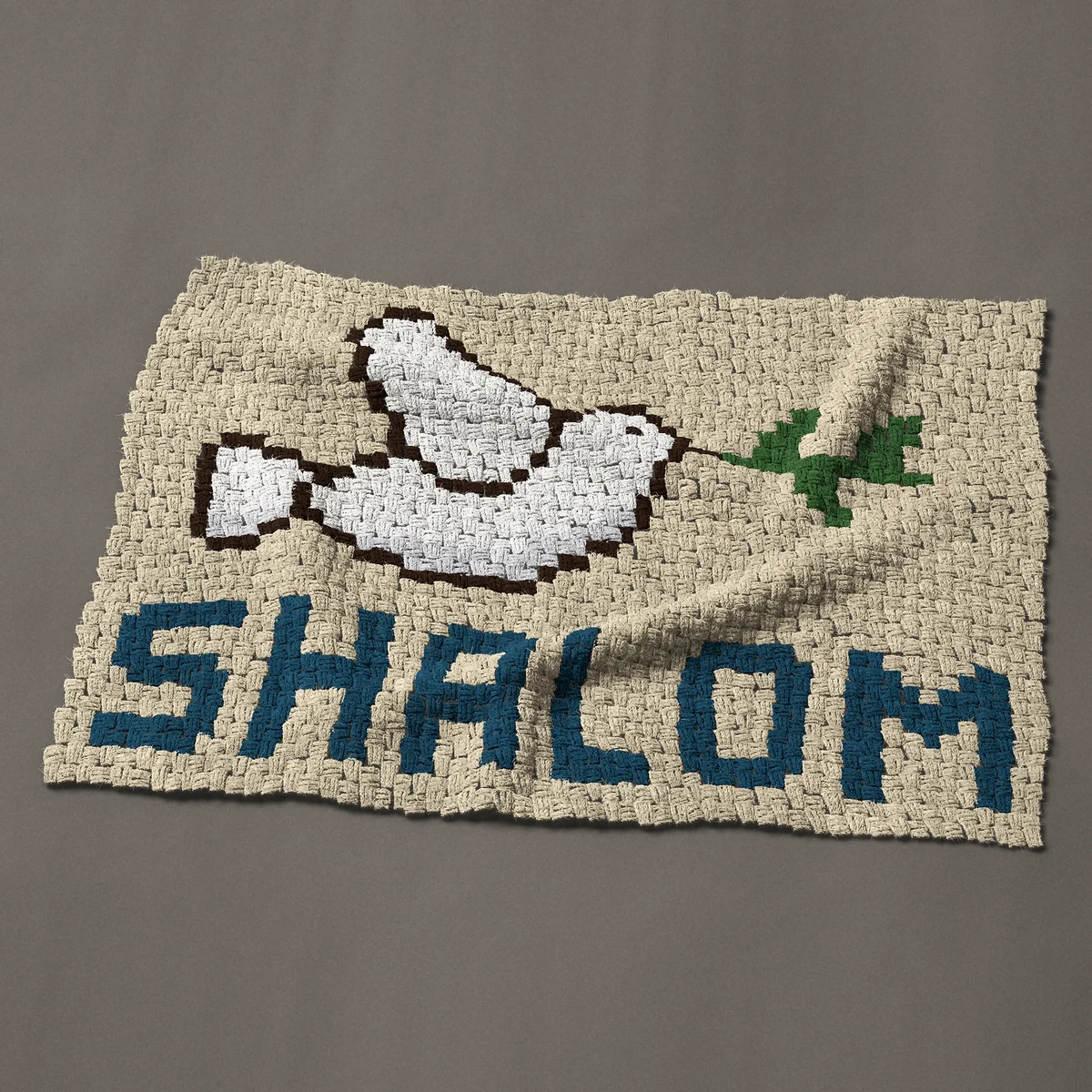 A baby blanket worked corner to corner, 42½ by 29¼ inches: Shalom with a white dove and an olive branch, 57 by 39 blocks