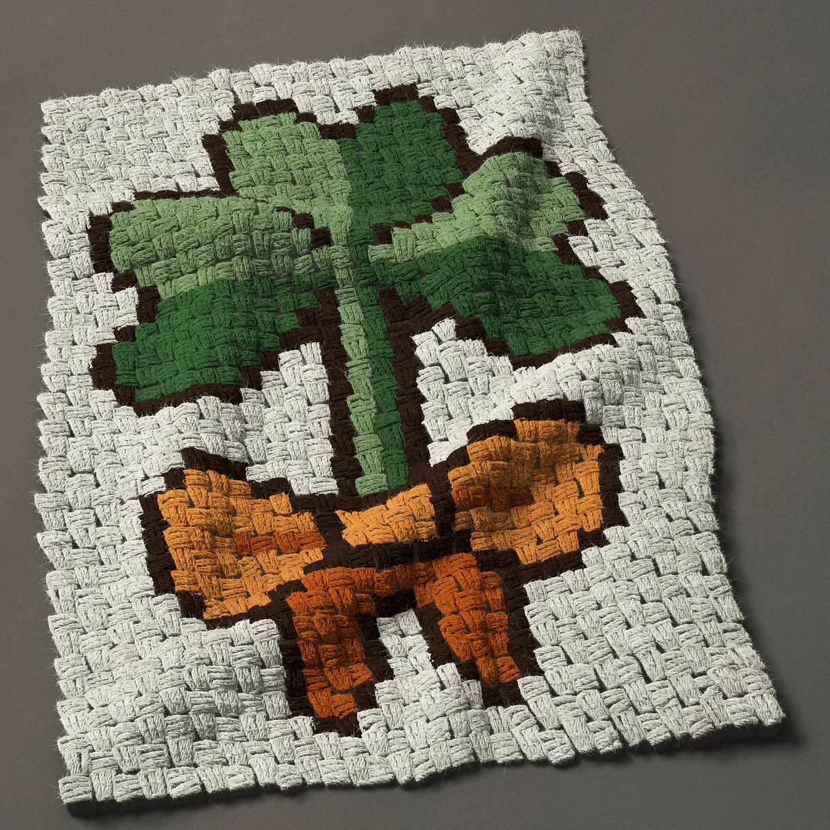 A panel worked corner to corner, 22½ by 30¾ inches: Shamrock tied with an orange bow for St Patrick's Day, 30 by 41 blocks