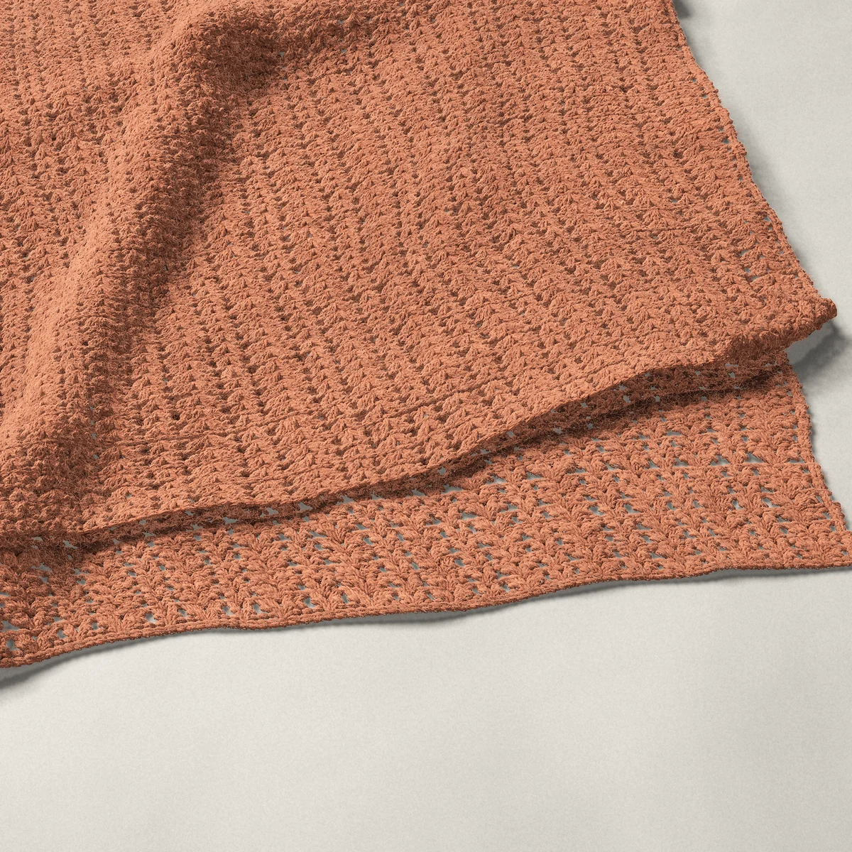 A throw in shell and V-stitch columns, 53¾ by 66 inches, folded in half with a corner turned back
