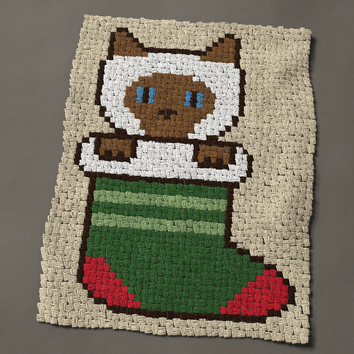A baby blanket worked corner to corner, 30 by 40½ inches: Siamese cat peeking out of a green Christmas stocking, 40 by 54 blocks