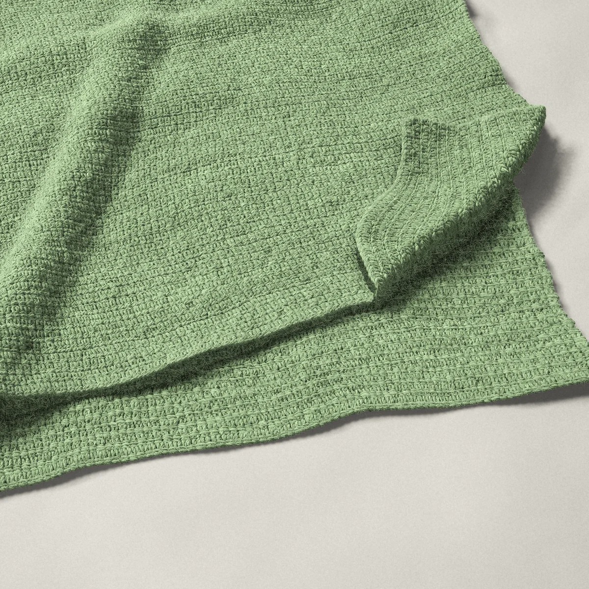 A throw in single crochet, 50¼ by 60 inches, folded in half with a corner turned back