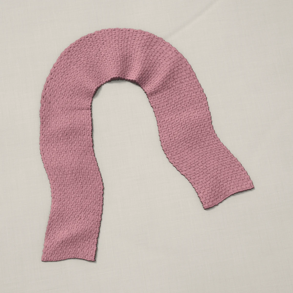 A scarf in single and double crochet pairs, 7 by 60 inches, lying in a loose bend