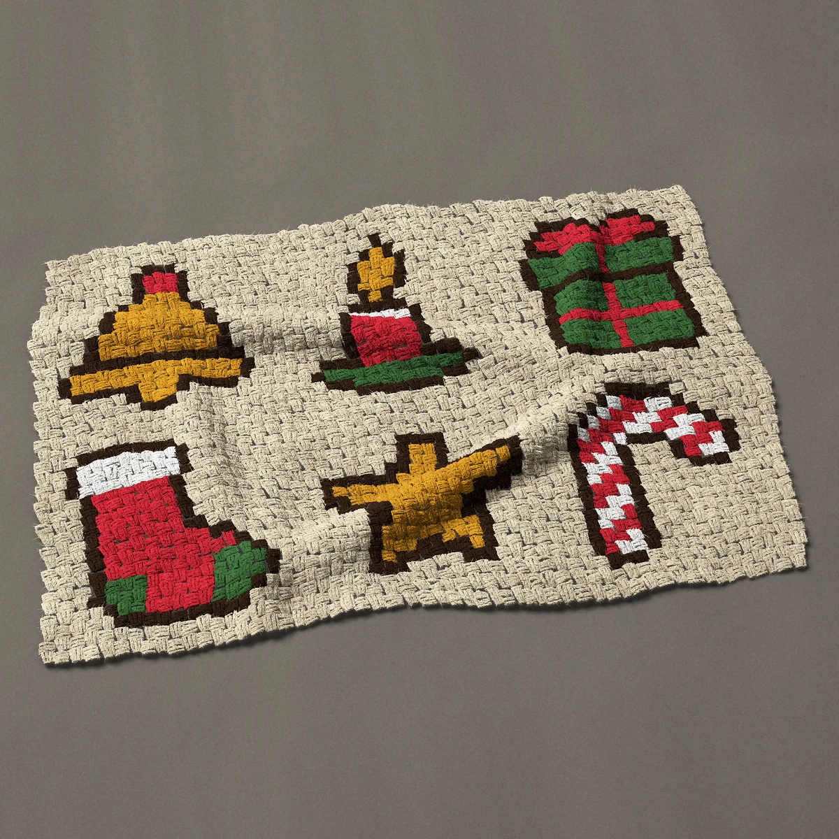 A baby blanket worked corner to corner, 42½ by 29¼ inches: Six Christmas motifs: bell, stocking and more, 57 by 39 blocks