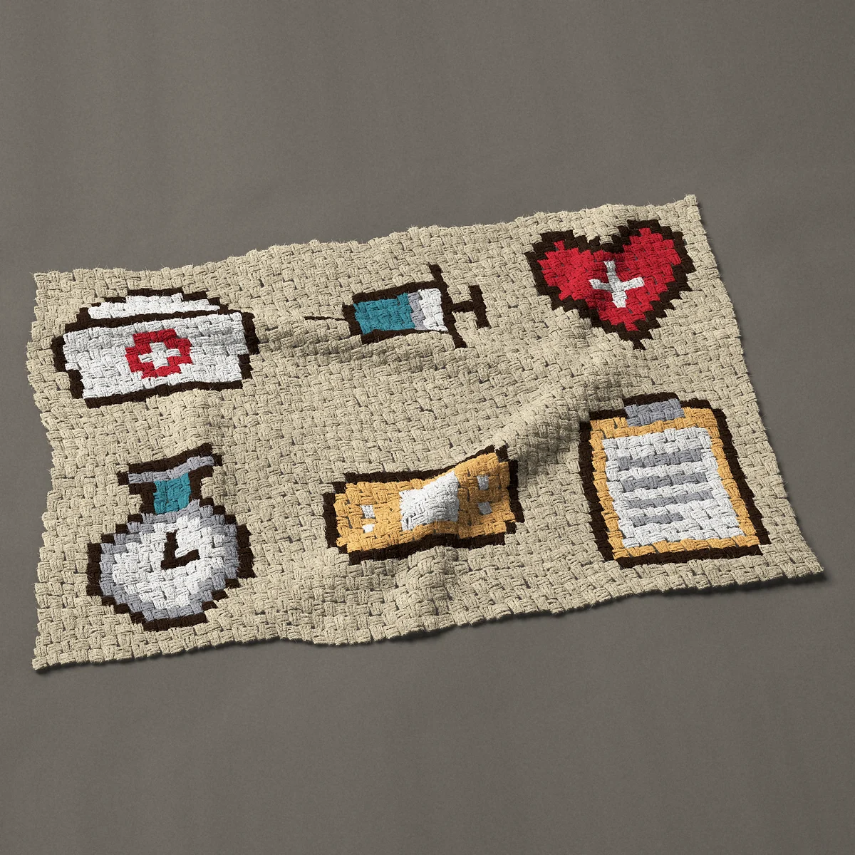 A baby blanket worked corner to corner, 46½ by 30¾ inches: Six nurse motifs with cap, syringe and heart, 62 by 41 blocks