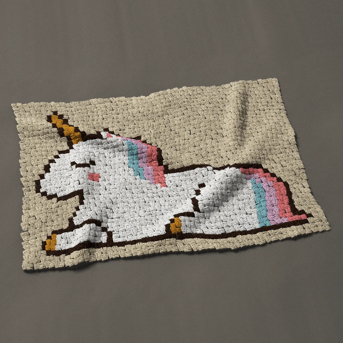 A baby blanket worked corner to corner, 41 by 28½ inches: Sleeping unicorn lying down with a pastel mane and tail, 55 by 38 blocks