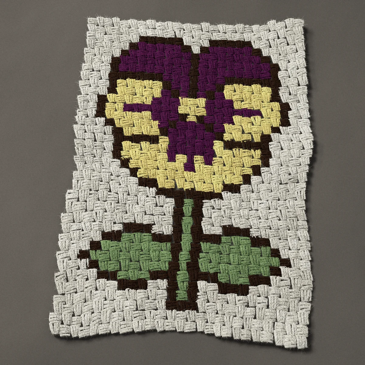 A panel worked corner to corner, 18¾ by 27 inches: Pansy flower on a stem with two leaves, 25 by 36 blocks