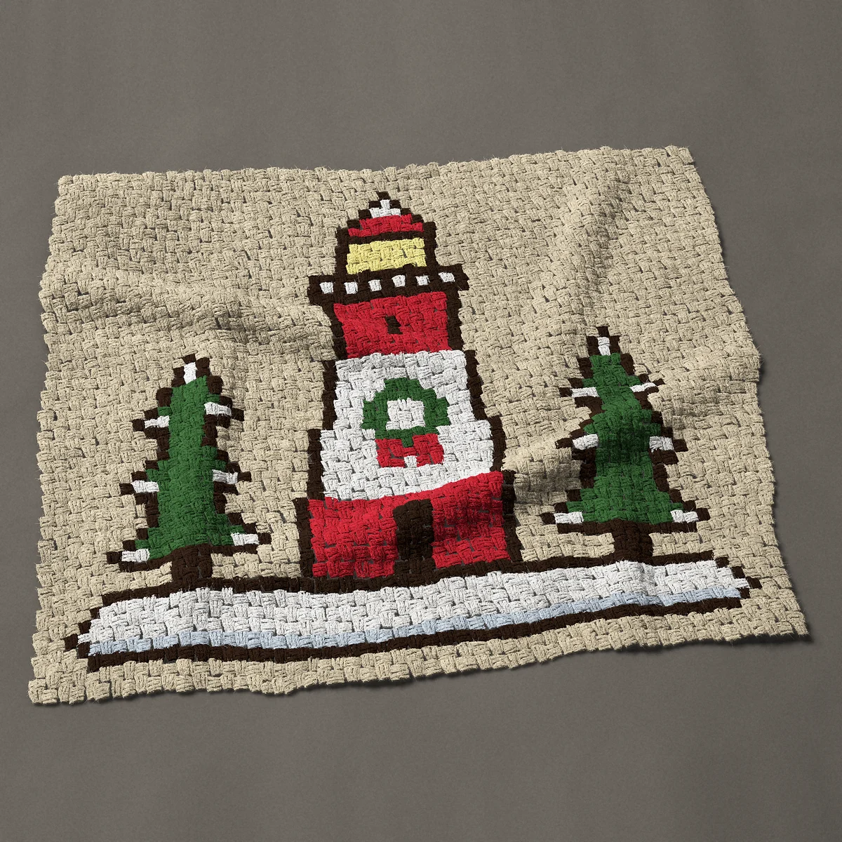 A baby blanket worked corner to corner, 42½ by 37½ inches: Snowy Christmas lighthouse with a wreath and pine trees, 57 by 50 blocks
