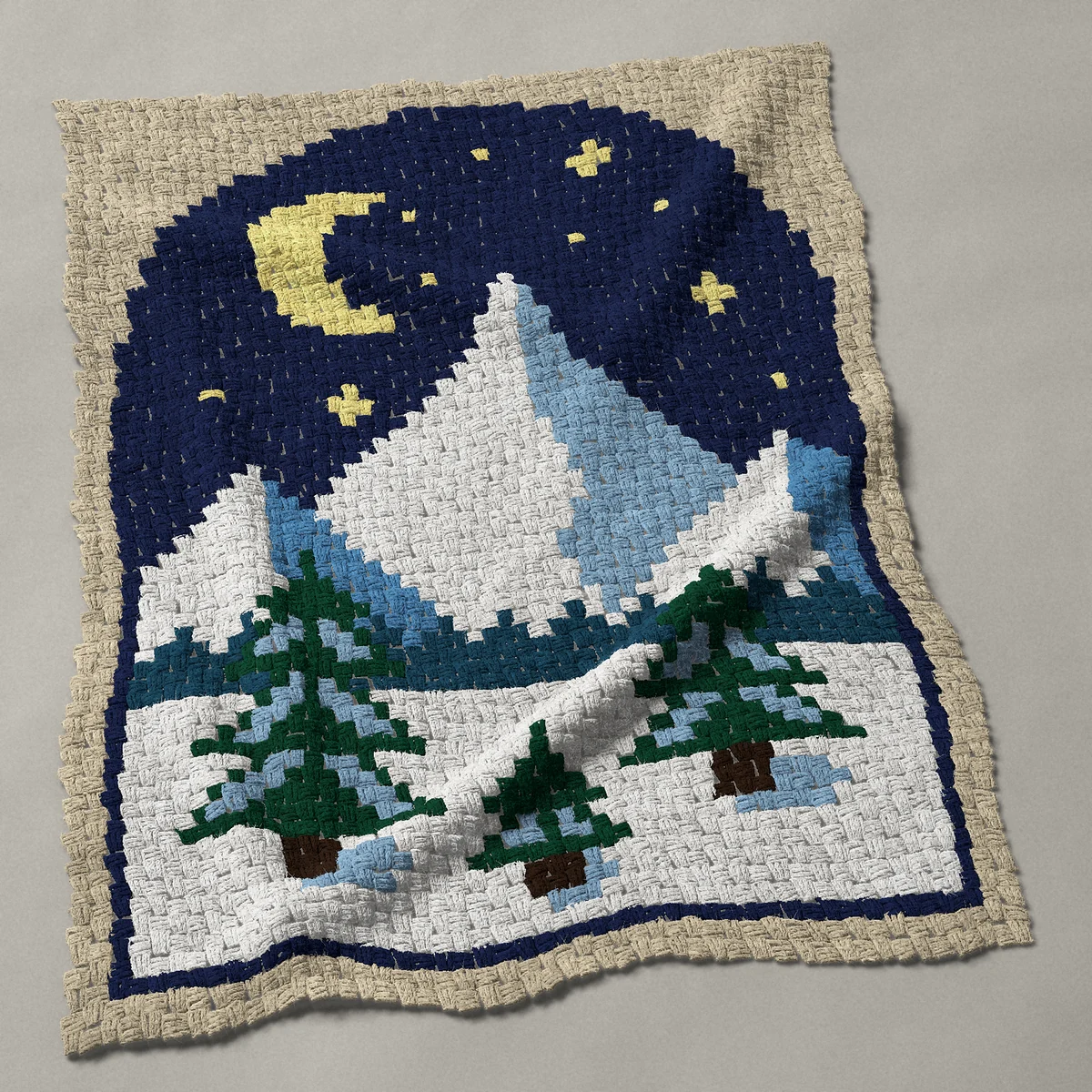 A baby blanket worked corner to corner, 38 by 50 inches: Snowy mountain night with crescent moon and pines, 51 by 67 blocks