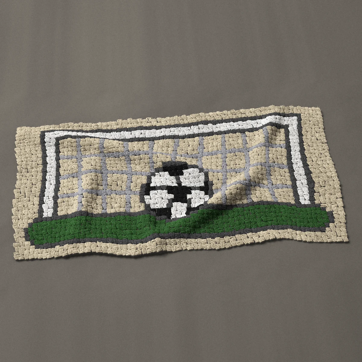 A baby blanket worked corner to corner, 50 by 25½ inches: Soccer goal with a net and a ball on the grass, 67 by 34 blocks