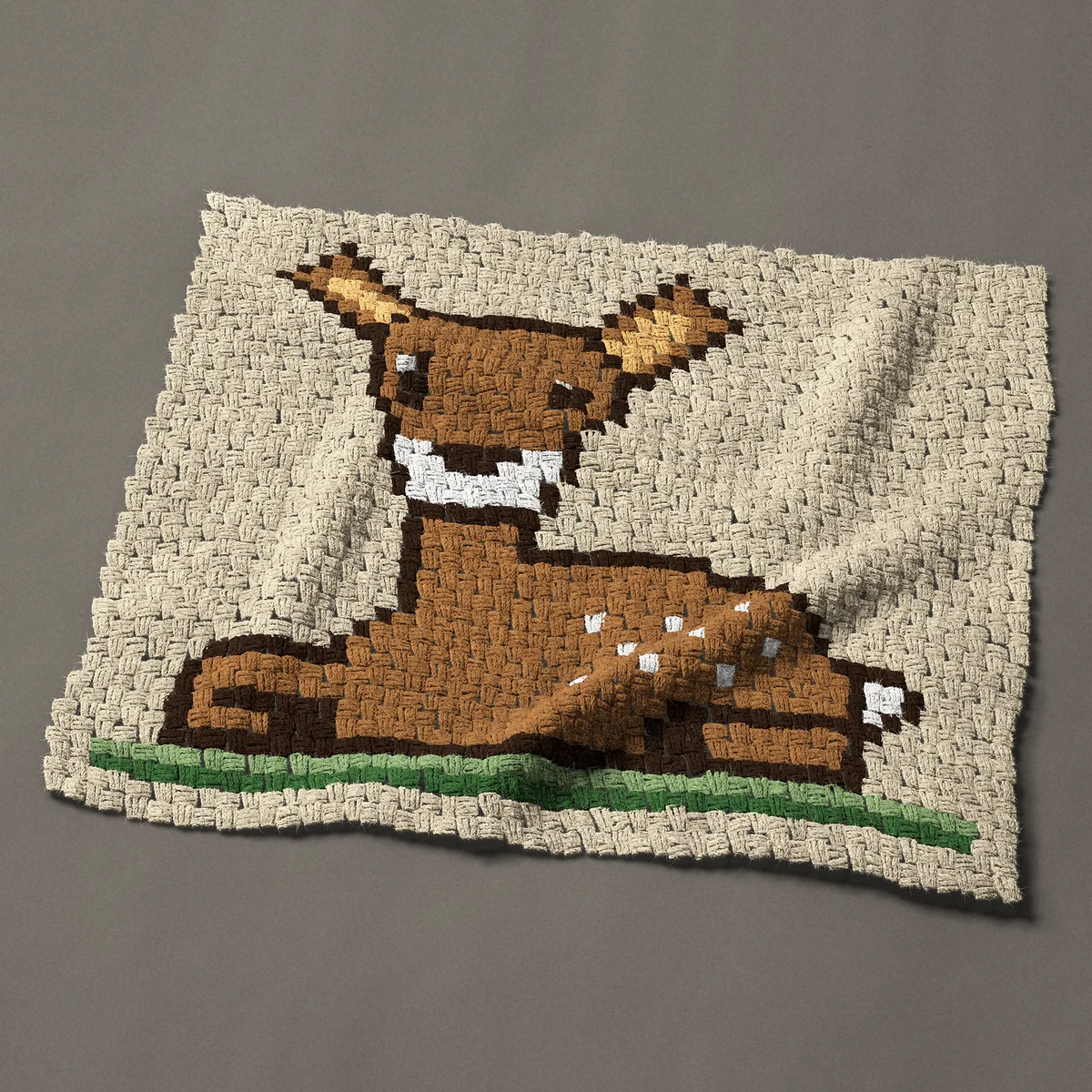 A baby blanket worked corner to corner, 36¾ by 30¾ inches: Spotted fawn lying down in the grass, a baby deer, 49 by 41 blocks