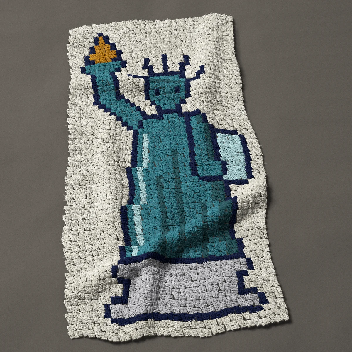 A baby blanket worked corner to corner, 24¾ by 49½ inches: Statue of Liberty standing on her pedestal, full figure, 33 by 66 blocks