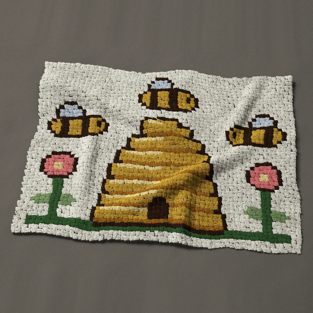 A lap blanket worked corner to corner, 47 by 37½ inches: Straw bee skep beehive with three bees and flowers, 63 by 50 blocks