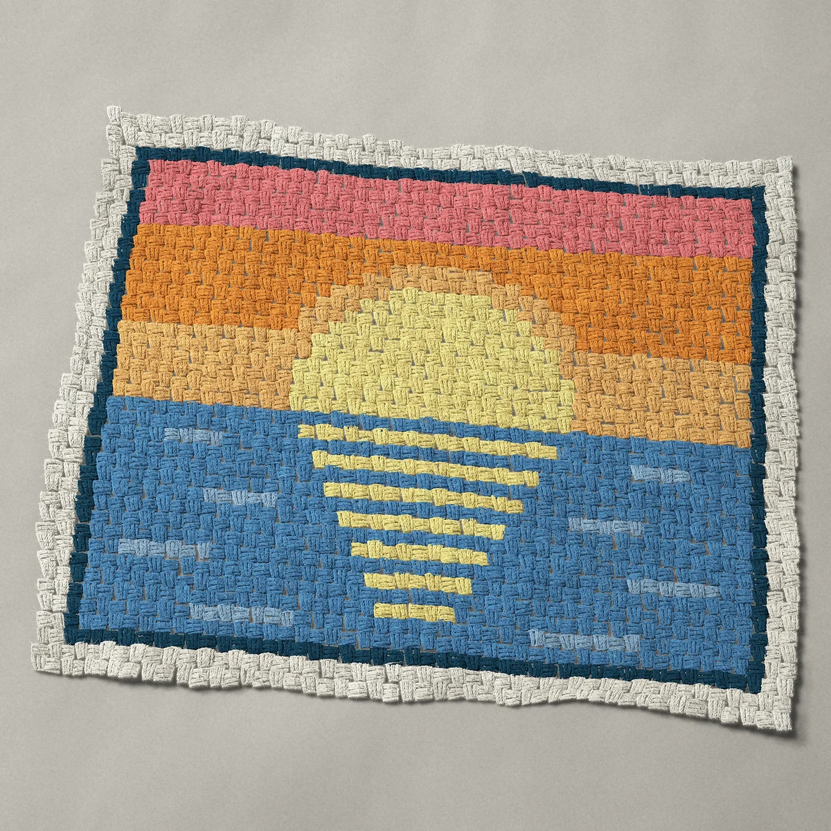 A baby blanket worked corner to corner, 36¾ by 30¾ inches: Sun on the ocean horizon, a sunrise or sunset at sea, 49 by 41 blocks