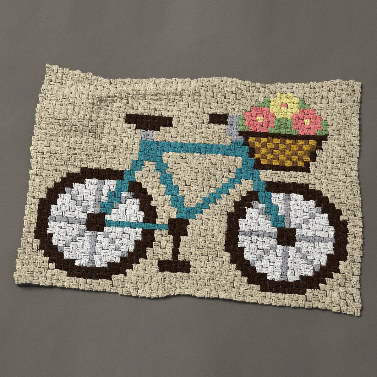 A baby blanket worked corner to corner, 39½ by 30 inches: Teal bicycle, a bike with a wicker basket of flowers, 53 by 40 blocks