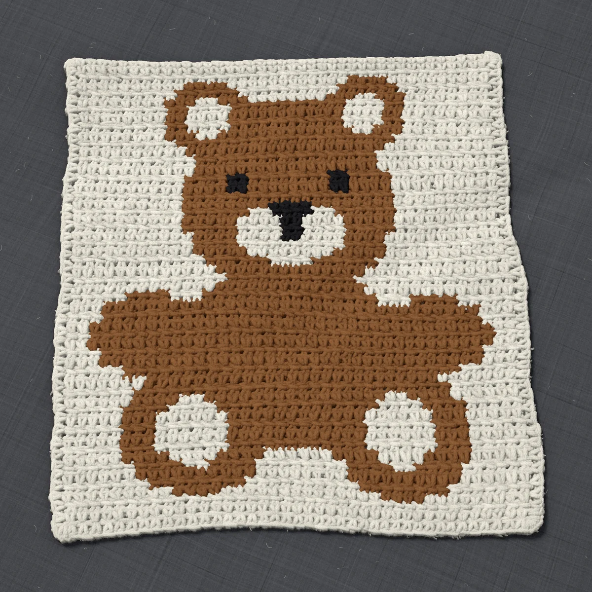 A pillow front in single crochet, 12.3 by 13.6 inches: a teddy bear in brown and black on a cream ground, 40 stitches by 51 rows