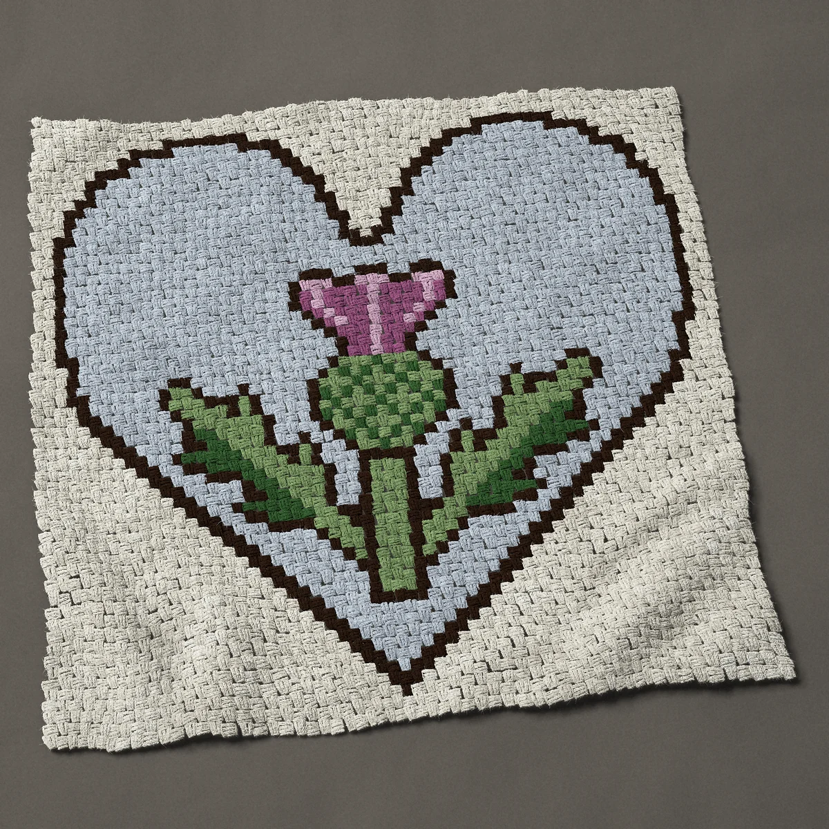 A panel worked corner to corner, 45½ by 44 inches: Thistle on a pale blue heart with two spiky leaves, 61 by 59 blocks