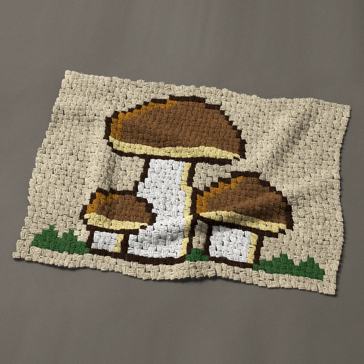 A baby blanket worked corner to corner, 39 by 29¼ inches: Three brown mushrooms growing together in the grass, 52 by 39 blocks