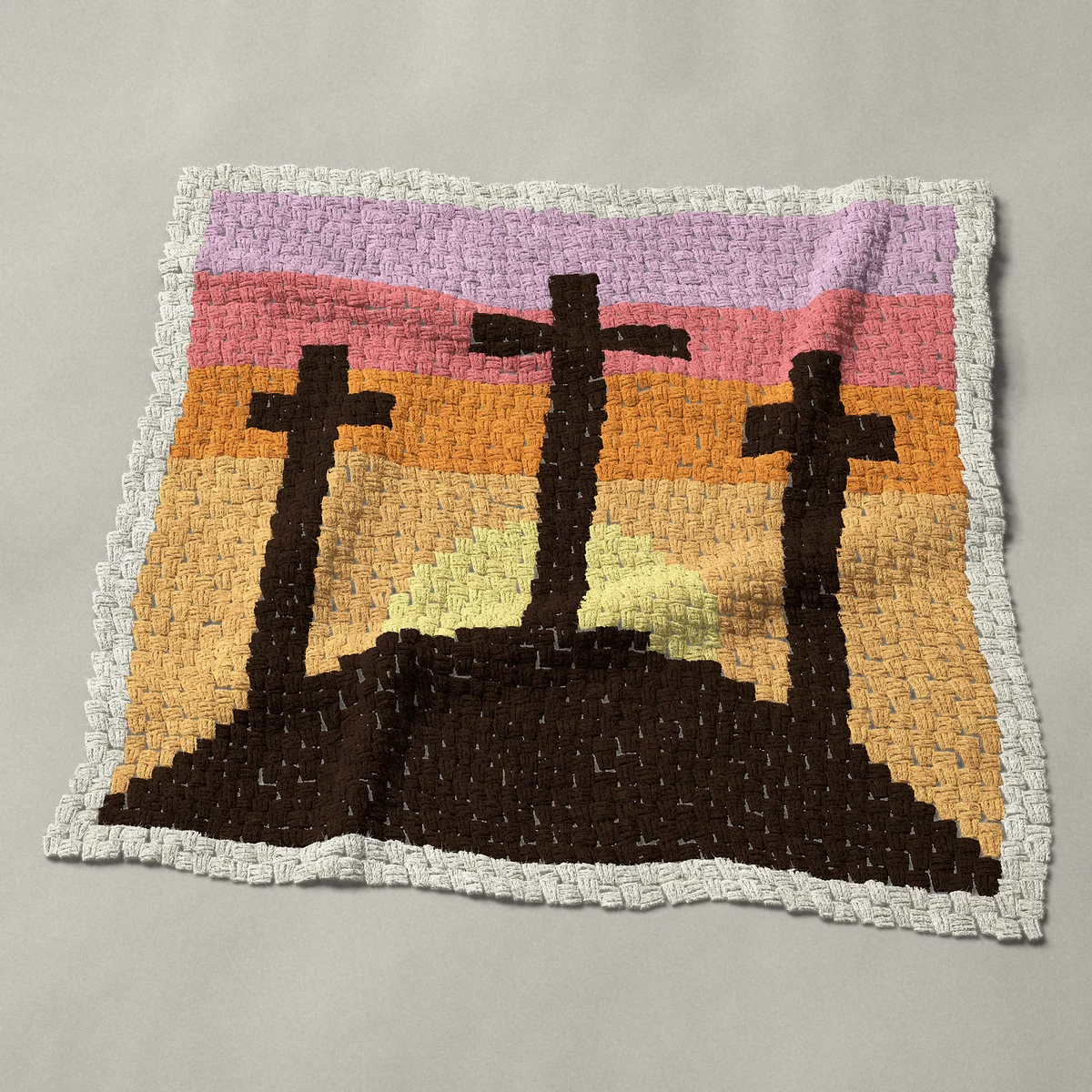 A baby blanket worked corner to corner, 38 by 38 inches: Three crosses on a hill, religious Easter silhouette, 51 by 51 blocks