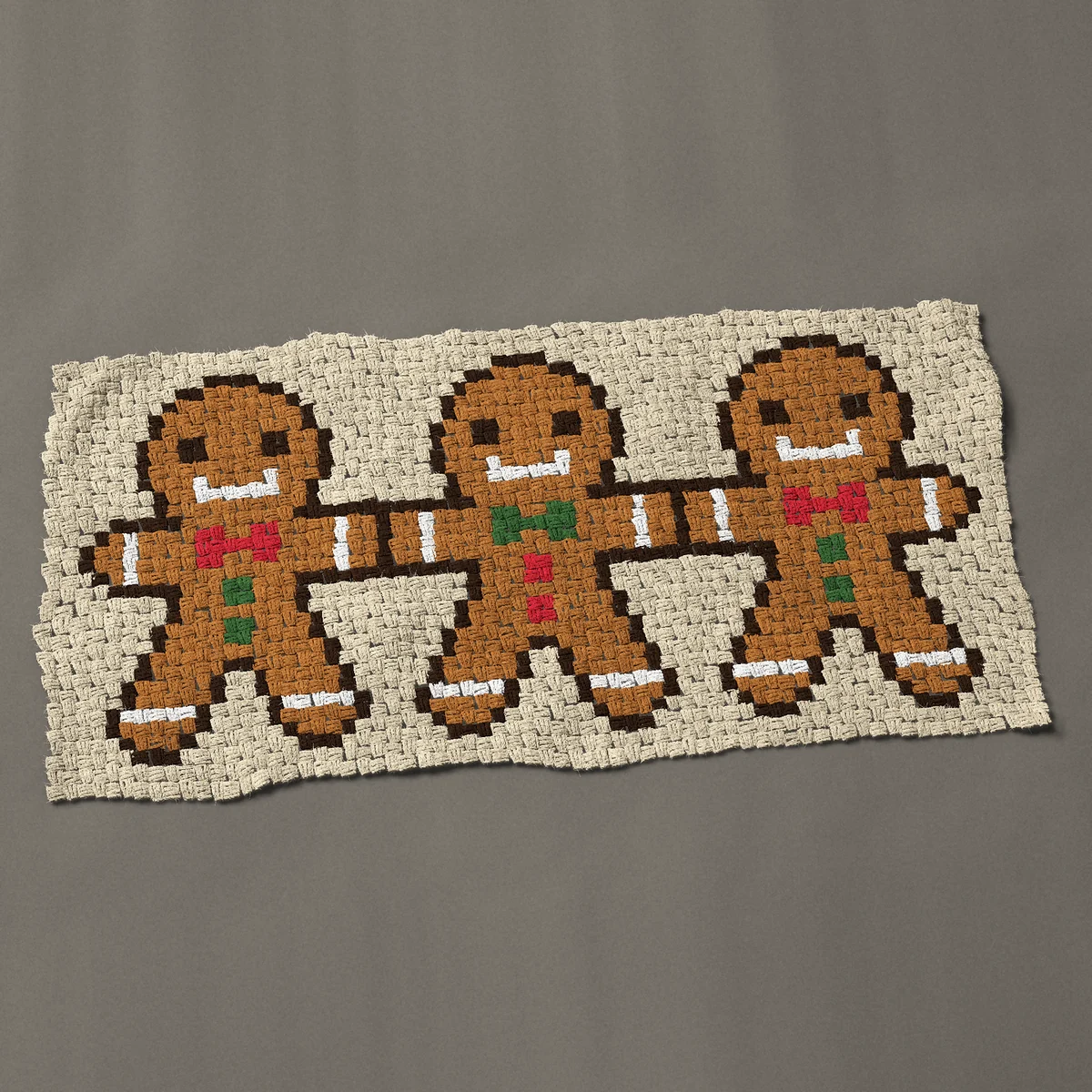 A baby blanket worked corner to corner, 51 by 24¾ inches: Three gingerbread men holding hands, 68 by 33 blocks