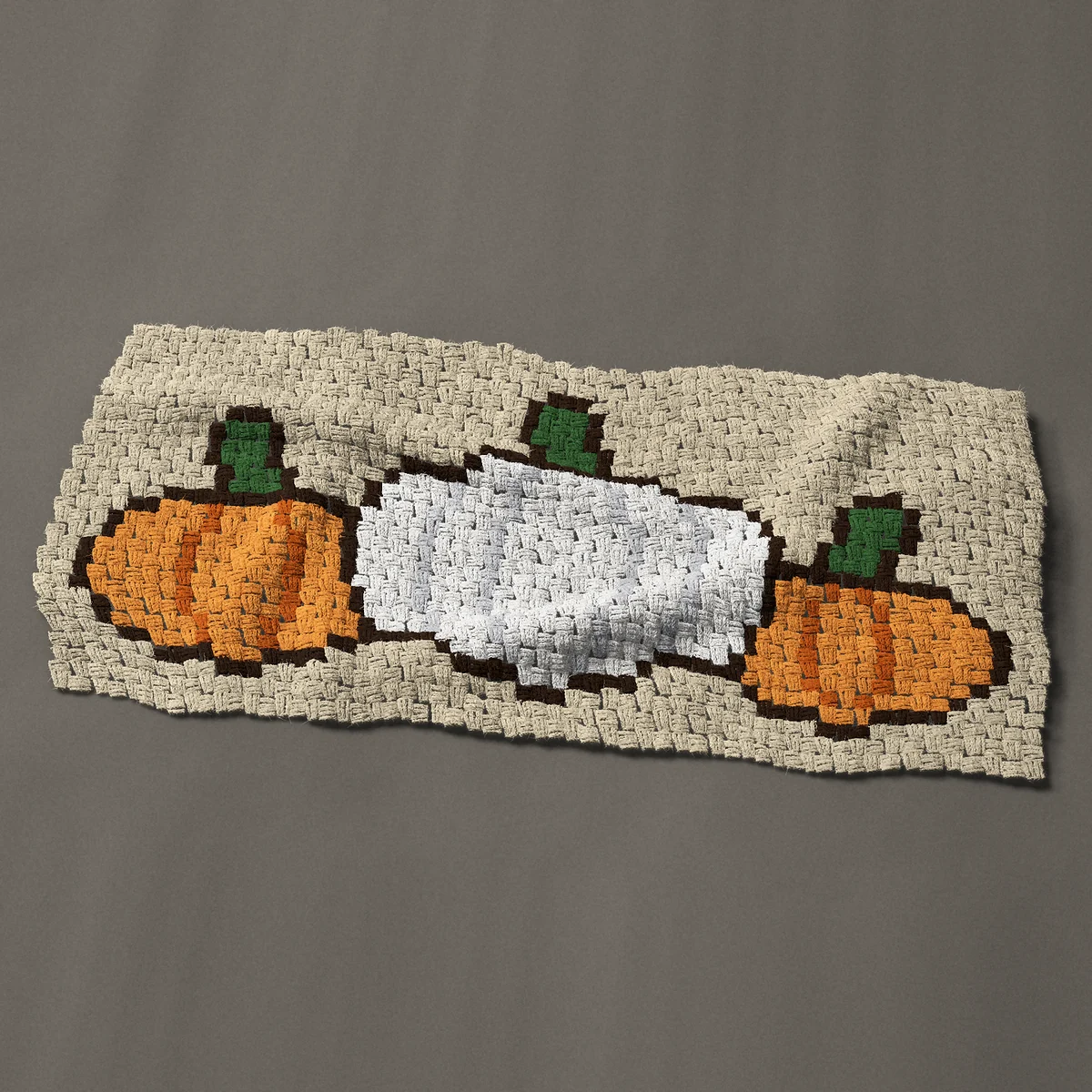 A panel worked corner to corner, 44 by 21¾ inches: Three pumpkins in a row, one white and two orange, 59 by 29 blocks