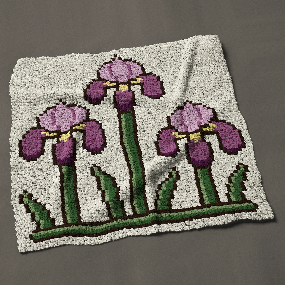 A throw worked corner to corner, 50 by 51 inches: Three purple irises at different heights, 67 by 68 blocks
