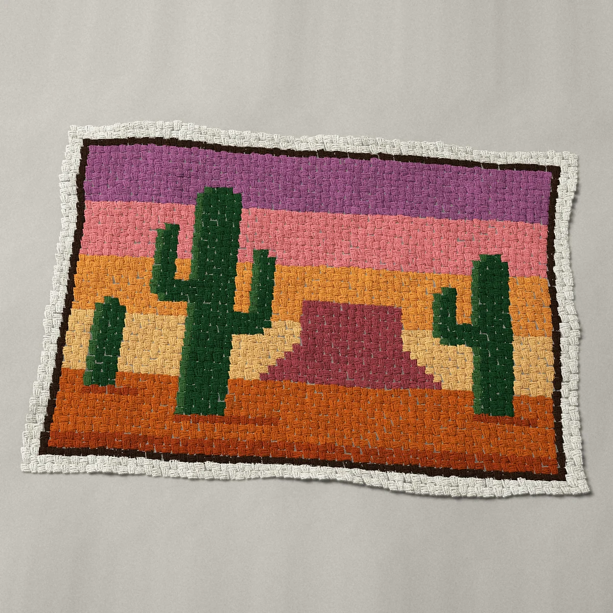 A baby blanket worked corner to corner, 51 by 36 inches: Desert sunset landscape with three saguaro cacti, 68 by 48 blocks