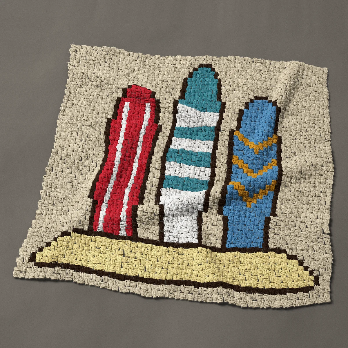 A panel worked corner to corner, 42½ by 42½ inches: Three surfboards standing in the sand at the beach, 57 by 57 blocks
