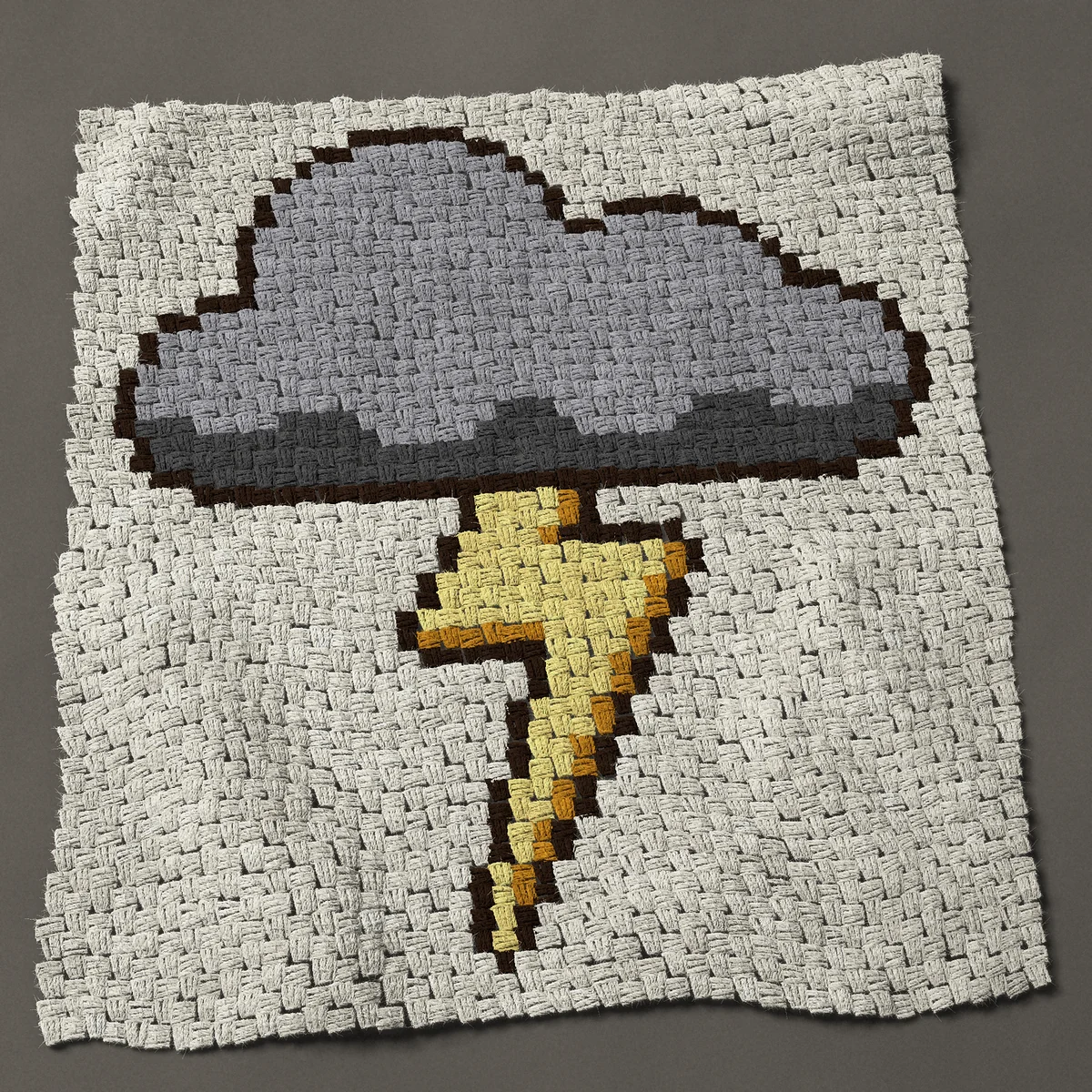 A baby blanket worked corner to corner, 33¾ by 37½ inches: Storm cloud with a lightning bolt, a gray thundercloud, 45 by 50 blocks