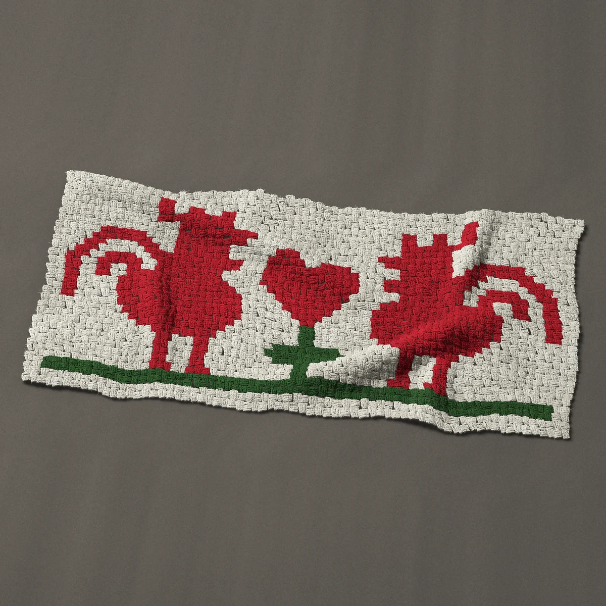 A baby blanket worked corner to corner, 51 by 24¾ inches: Two red folk art roosters facing a heart, 68 by 33 blocks