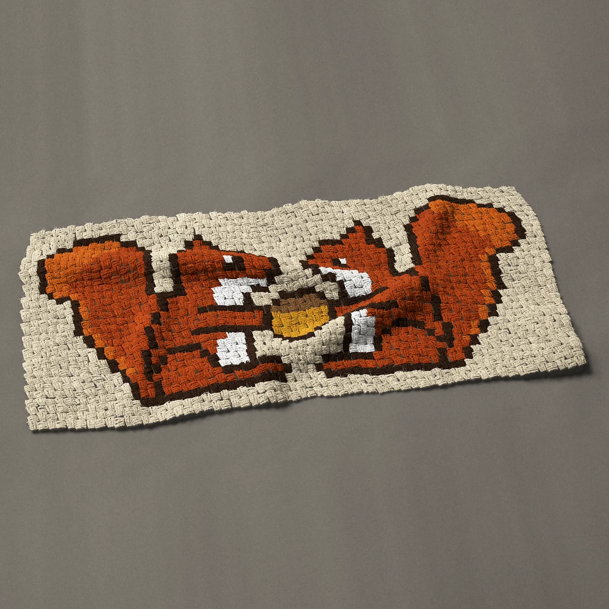 A panel worked corner to corner, 47 by 22½ inches: Two red squirrels sharing an acorn, 63 by 30 blocks