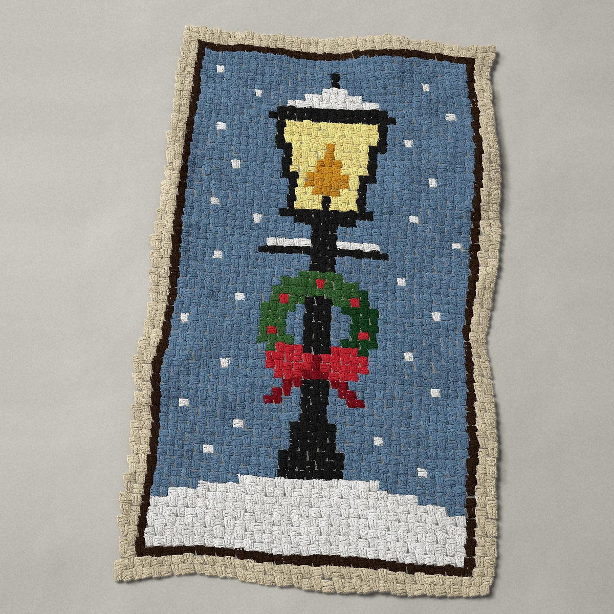 A baby blanket worked corner to corner, 29¼ by 50 inches: Victorian Christmas street lantern with wreath in snow, 39 by 67 blocks