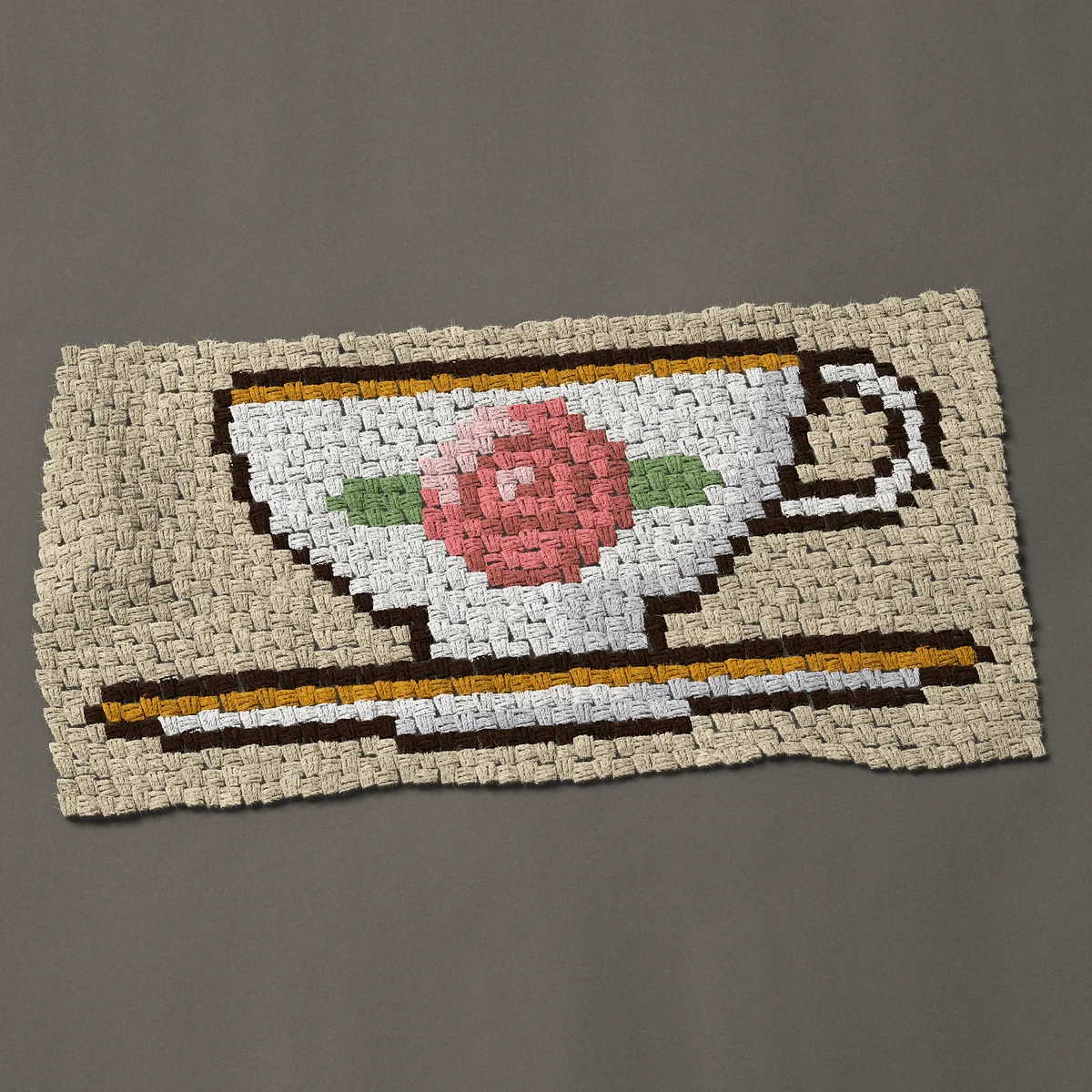 A panel worked corner to corner, 38 by 20¼ inches: Vintage china teacup and saucer with a pink rose, 51 by 27 blocks