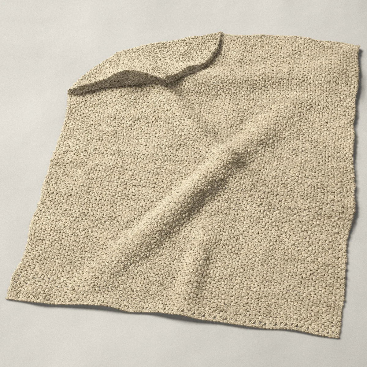 A baby blanket in wattle stitch, 31¾ by 40 inches, spread out with a corner turned over