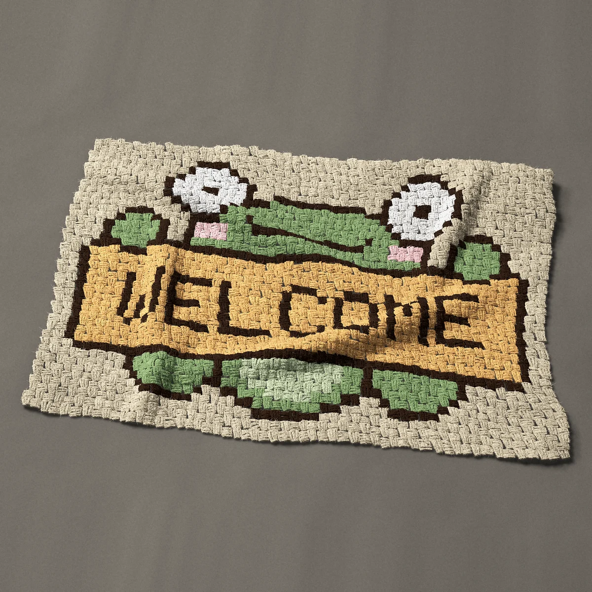 A baby blanket worked corner to corner, 41 by 28½ inches: Welcome frog holding a welcome sign, 55 by 38 blocks