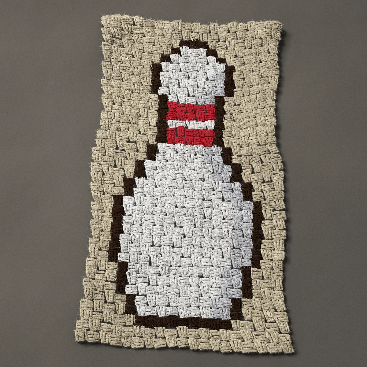 A panel worked corner to corner, 14¼ by 27 inches: White bowling pin with two red neck stripes, 19 by 36 blocks