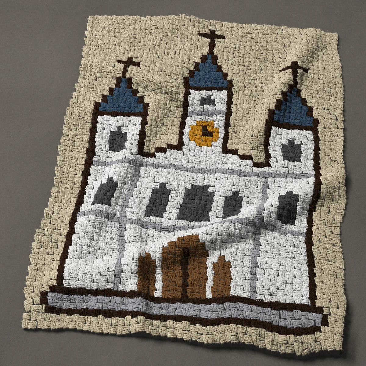 A lap blanket worked corner to corner, 35¼ by 48 inches: White New Orleans cathedral with three spires, 47 by 64 blocks