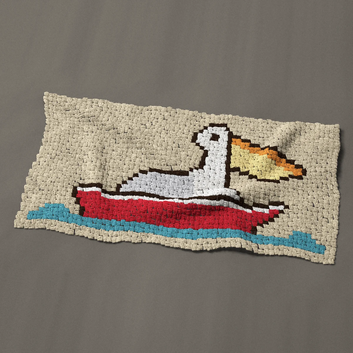 A baby blanket worked corner to corner, 48½ by 26¼ inches: Pelican sitting in a red rowboat on the water, 65 by 35 blocks