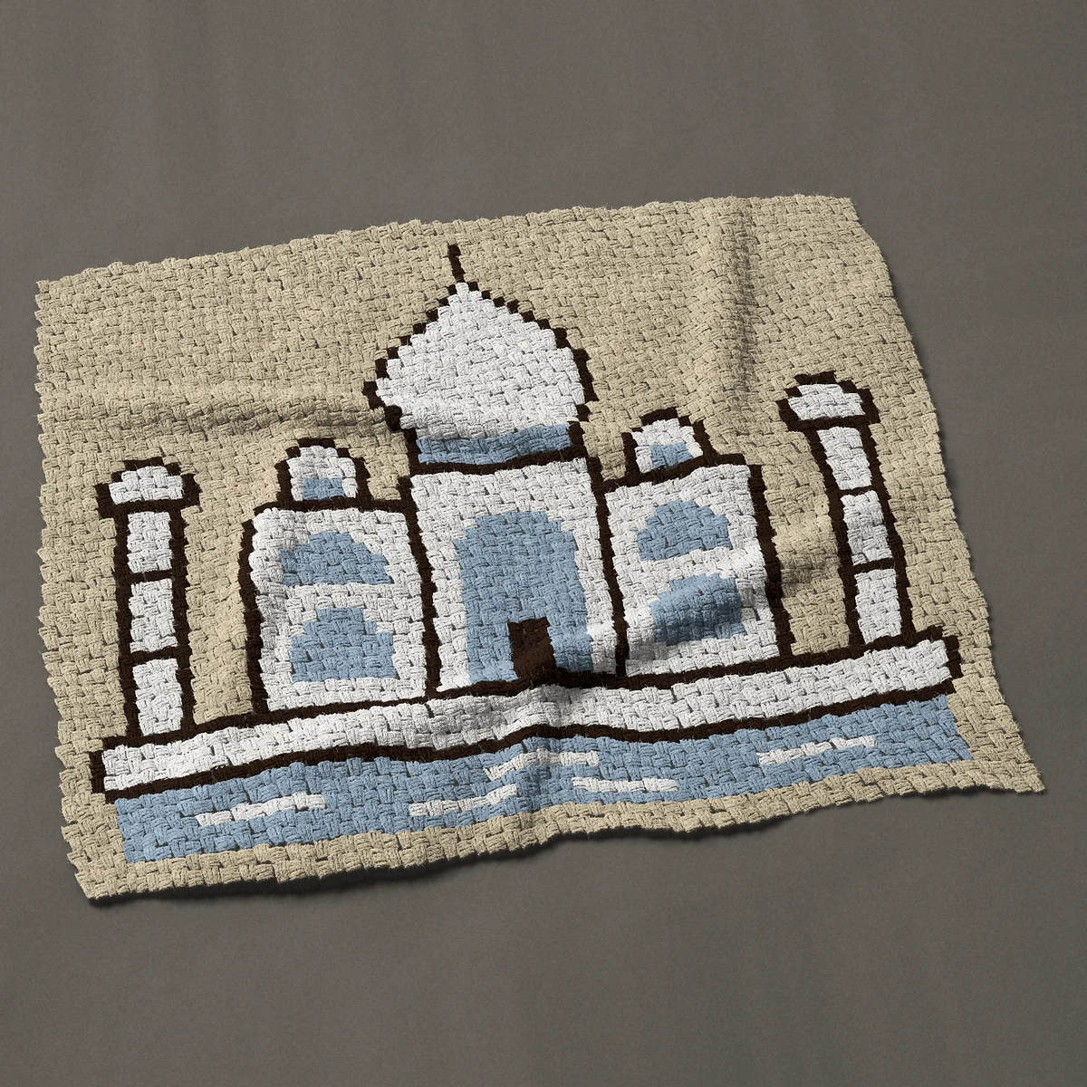 A panel worked corner to corner, 50 by 42½ inches: White Taj Mahal with two minarets and a reflecting pool, 67 by 57 blocks