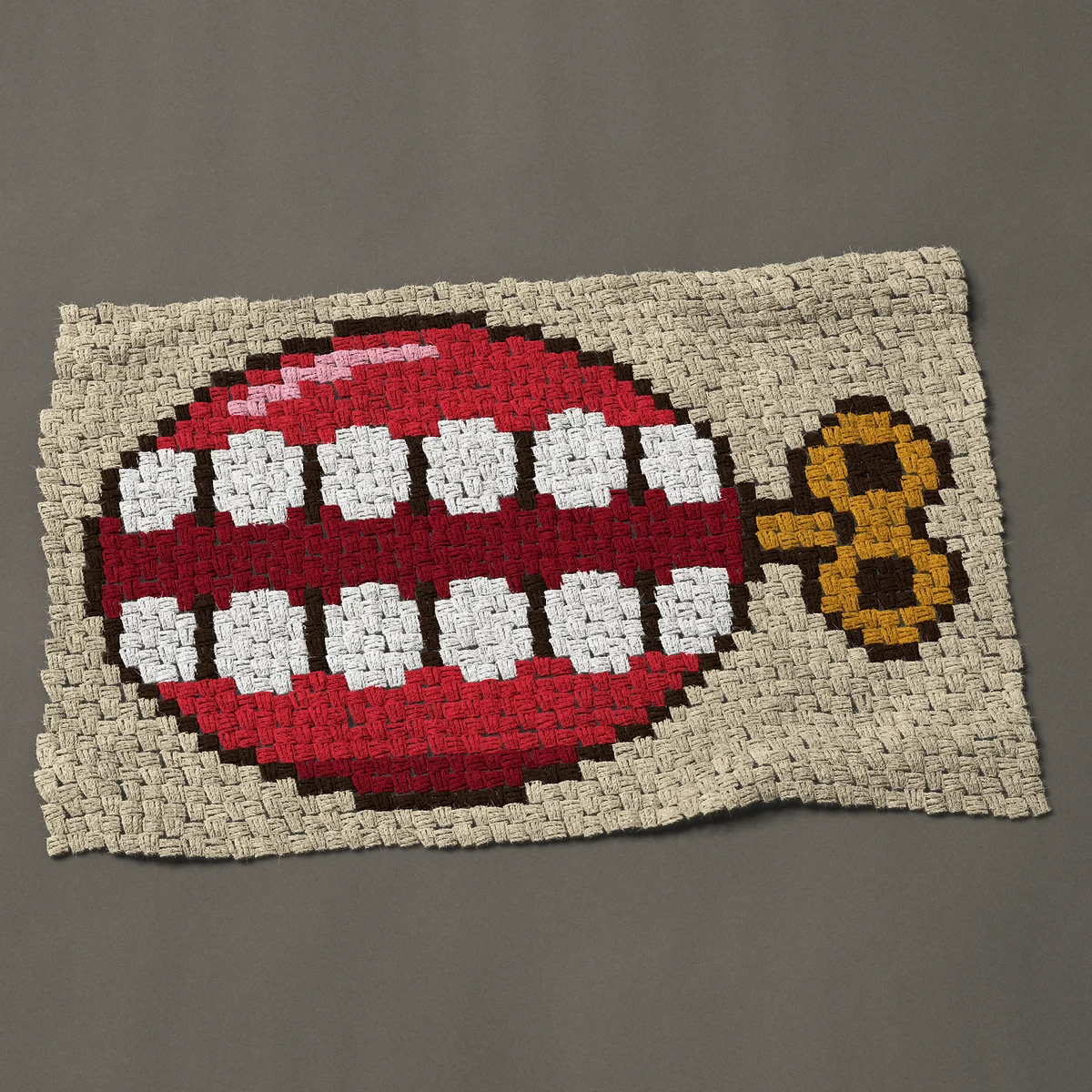 A baby blanket worked corner to corner, 39 by 25½ inches: Wind-up chattering teeth joke toy with a gold key, 52 by 34 blocks