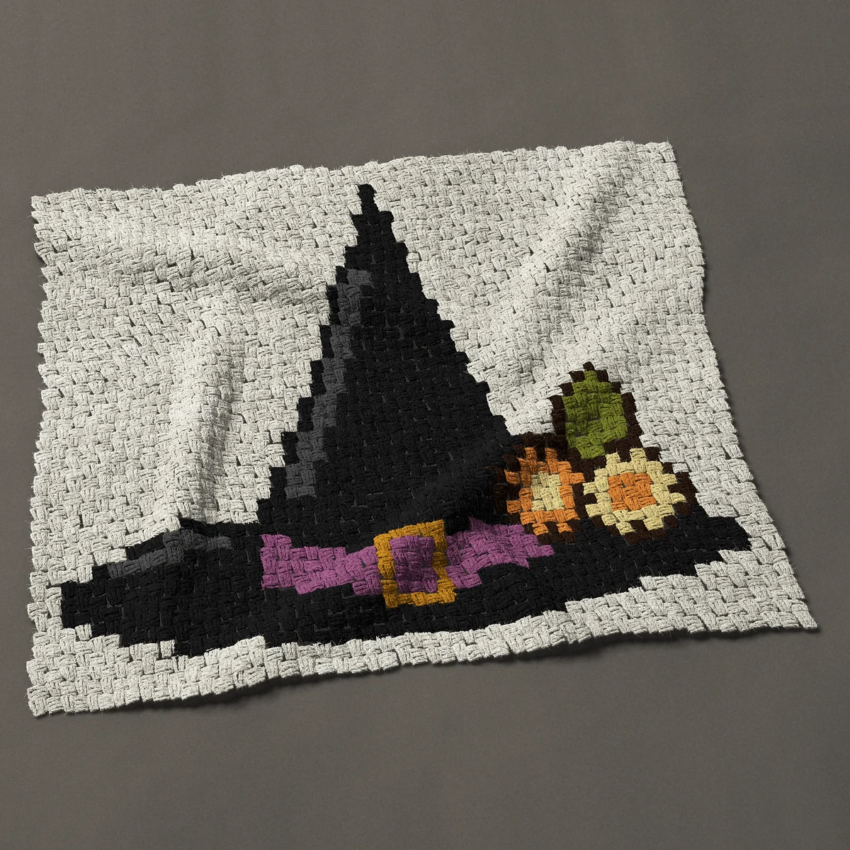 A baby blanket worked corner to corner, 39½ by 34½ inches: Witch hat with flowers and a gold buckle, 53 by 46 blocks