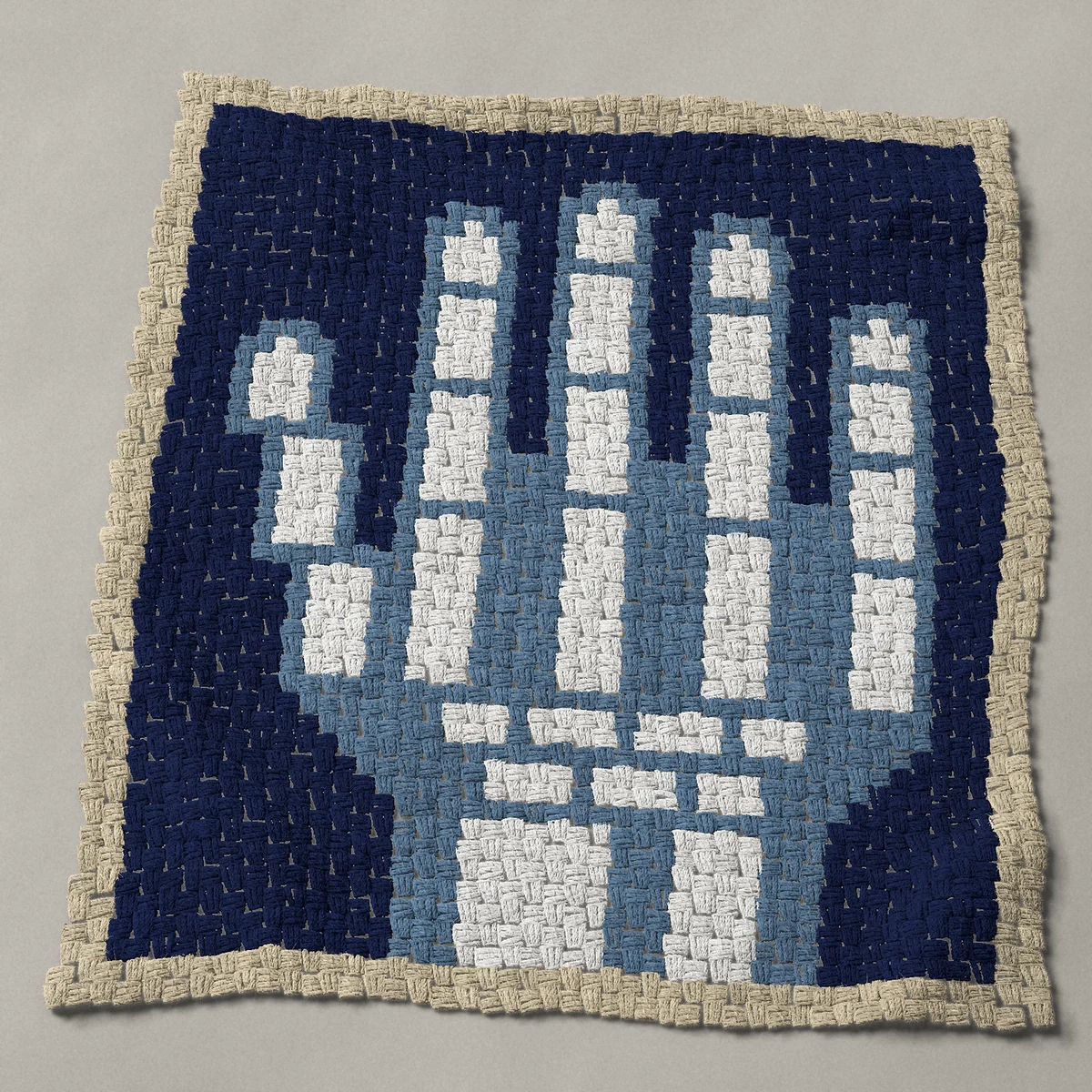 A baby blanket worked corner to corner, 33¾ by 38 inches: Hand X-ray with white skeleton hand bones on dark film, 45 by 51 blocks