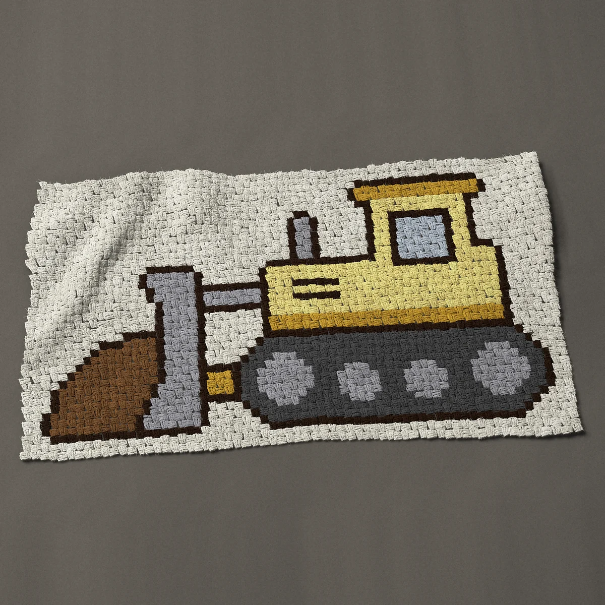 A baby blanket worked corner to corner, 49½ by 28½ inches: Yellow bulldozer, a construction vehicle pushing dirt, 66 by 38 blocks