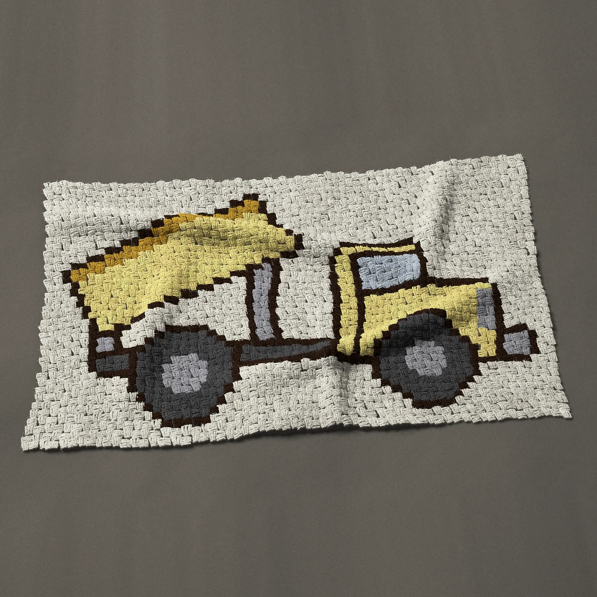 A baby blanket worked corner to corner, 47 by 29¼ inches: Yellow dump truck with its bed raised, side view, 63 by 39 blocks