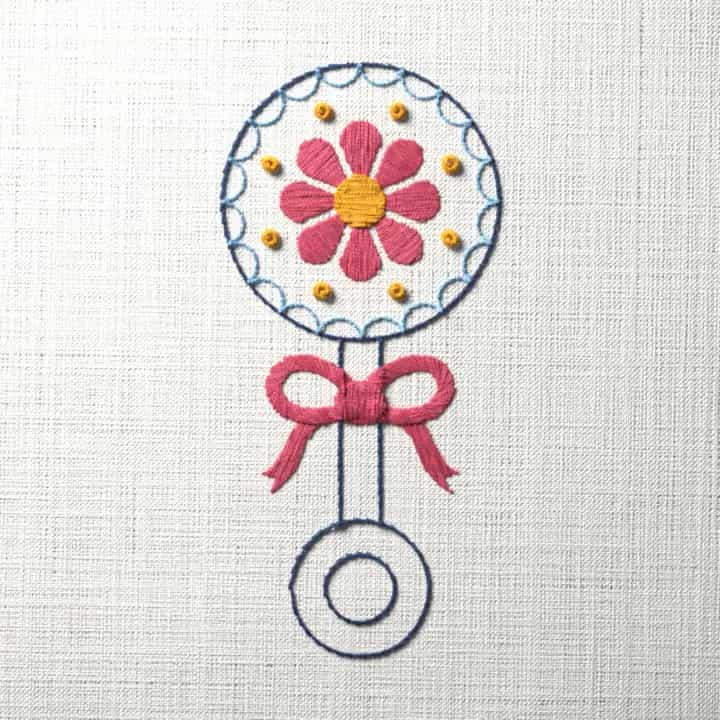 Baby rattle with a bow: preview of the stitched design