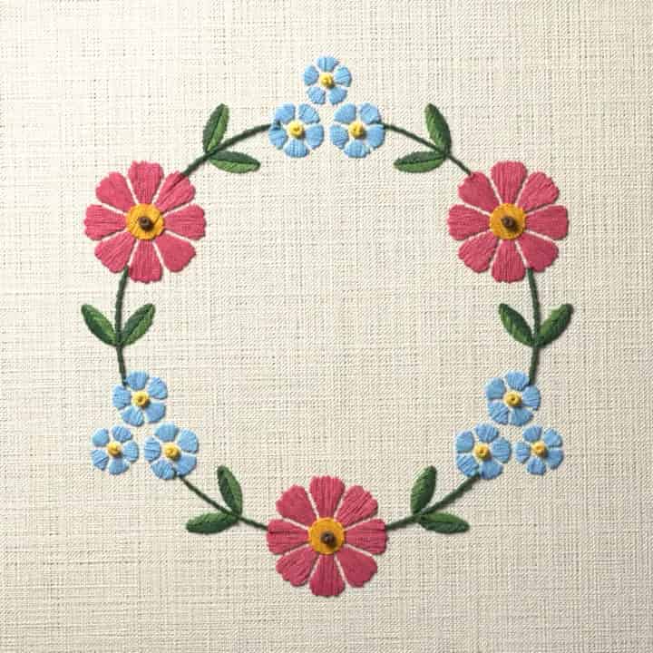 Cosmos and forget-me-not wreath: preview of the stitched design