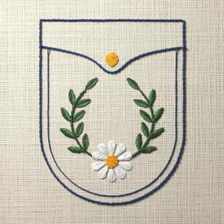 Flap pocket with laurel and daisy: preview of the stitched design