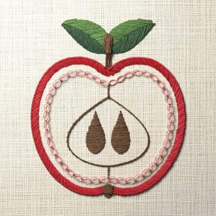 Halved apple with two leaves: preview of the stitched design