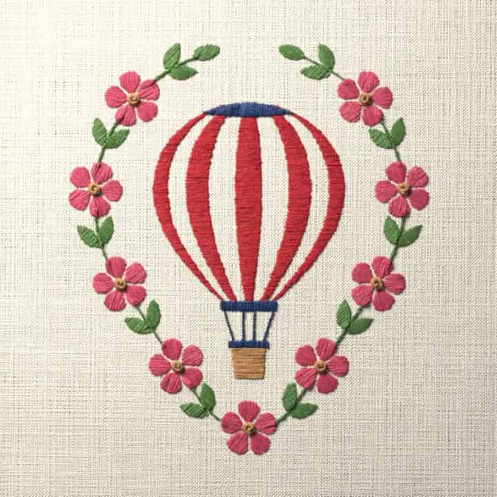 Hot-air balloon in a blossom wreath: preview of the stitched design