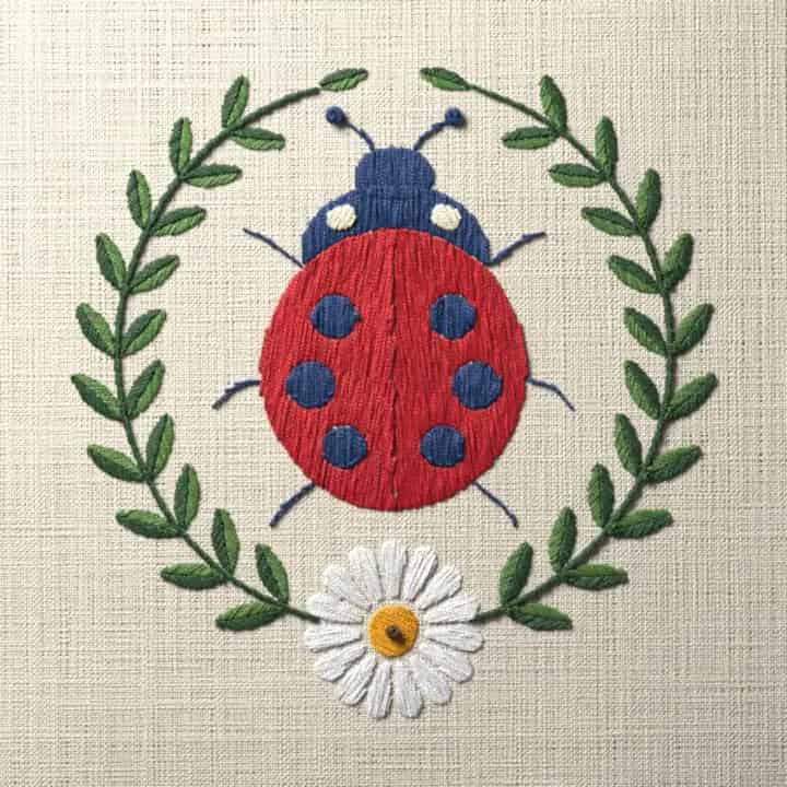 Ladybug in laurel wreath: preview of the stitched design