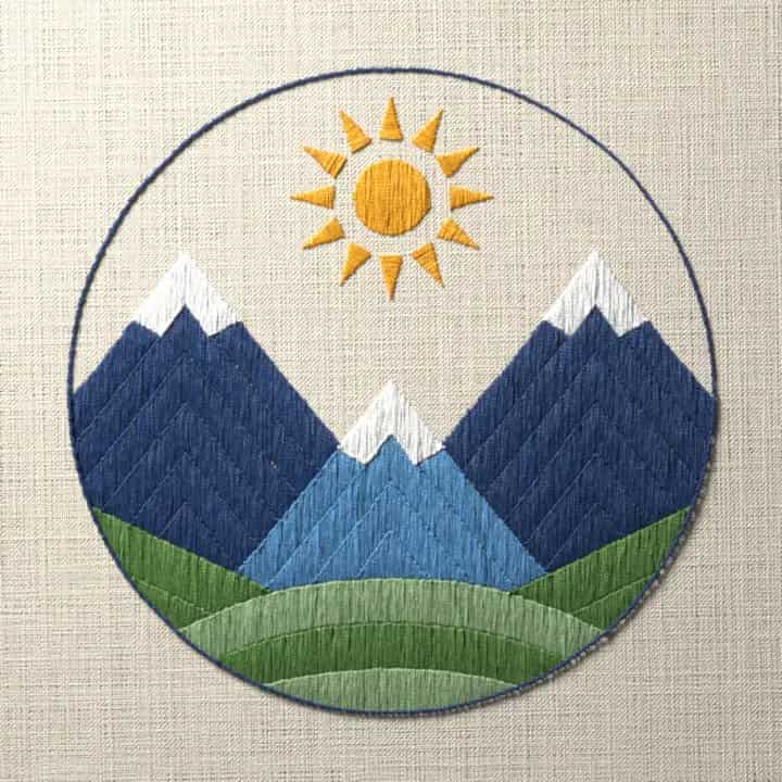 Mountains and sun in a ring: preview of the stitched design
